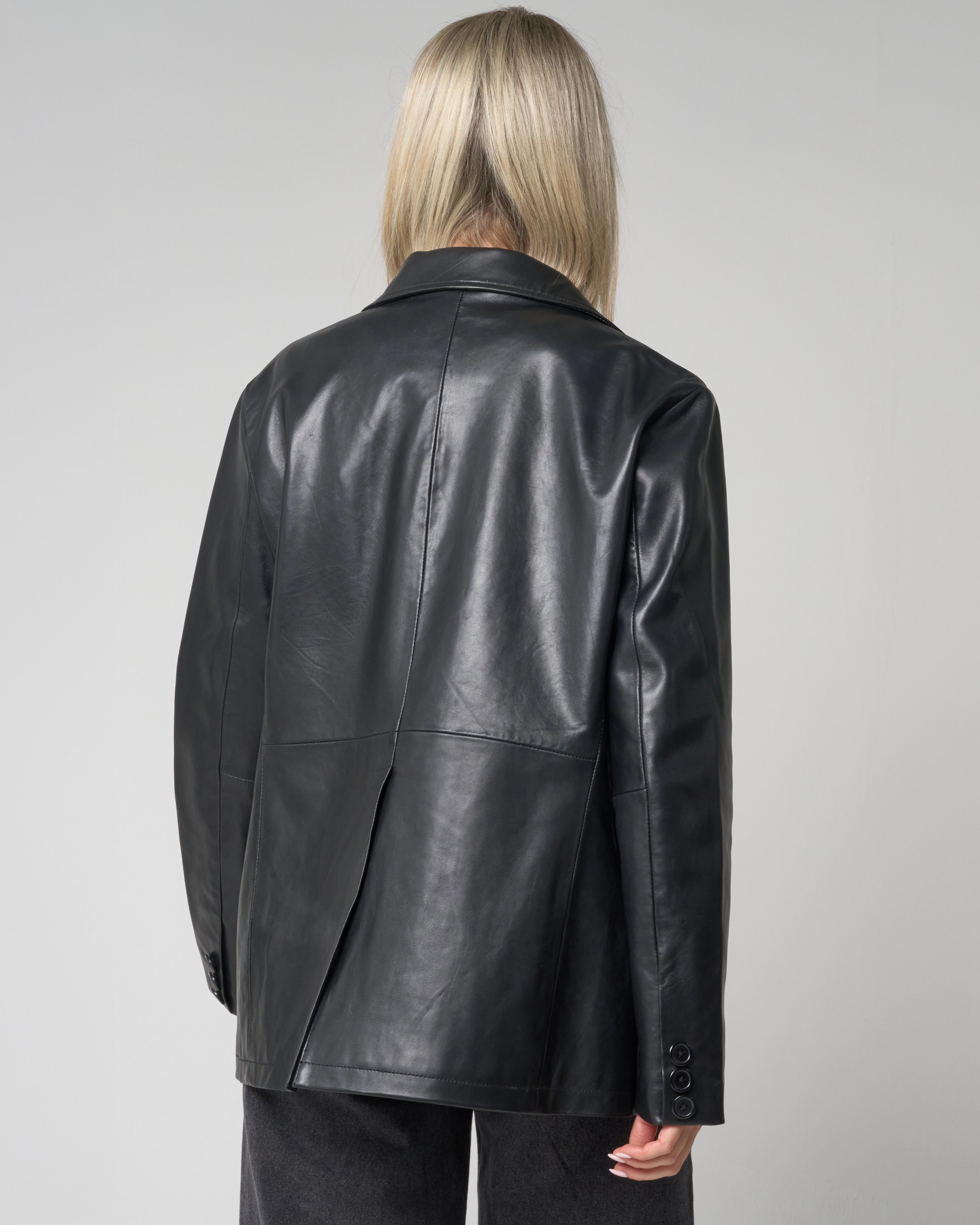 Back of the leather blazer jacket for women has a vent - with no logo or pattern.