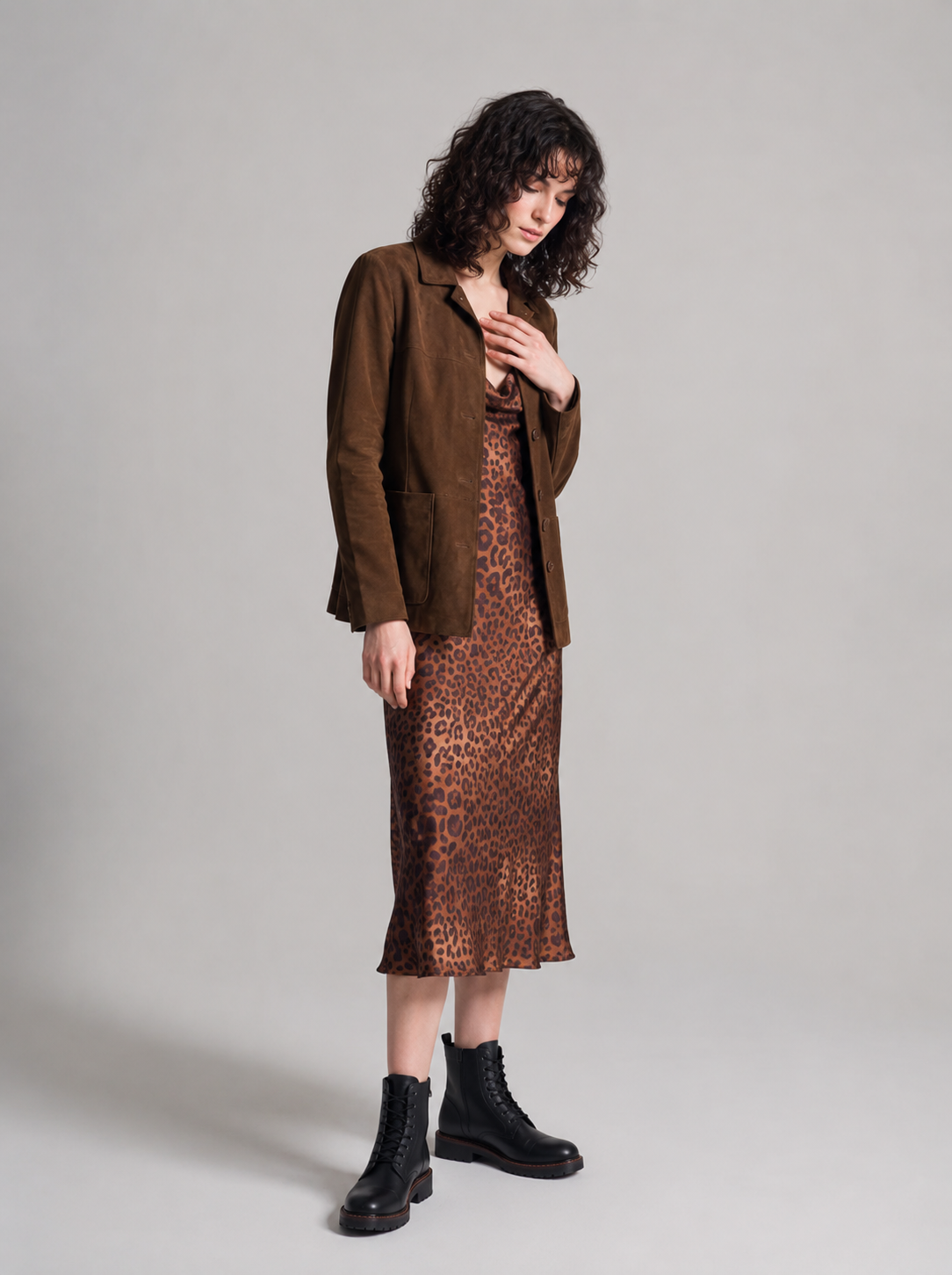 Image shows a woman wearing the buffalo suede car coat from Barneys Originals with a leopard print dress and Dr Martens boots.