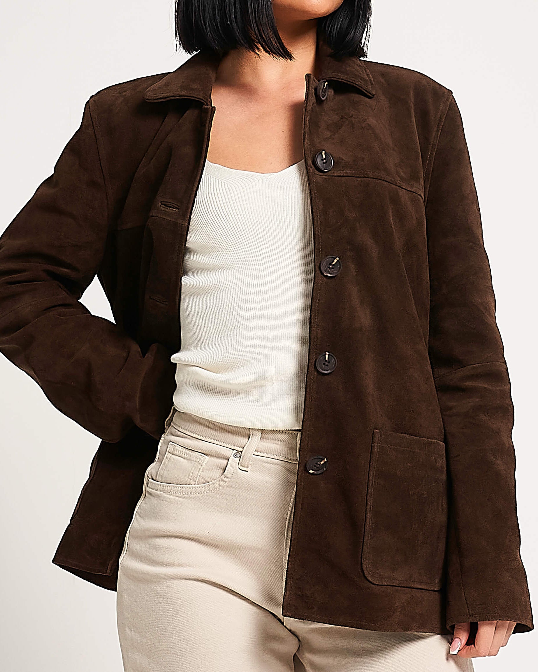 Brown suede jacket worn by a person on a white background