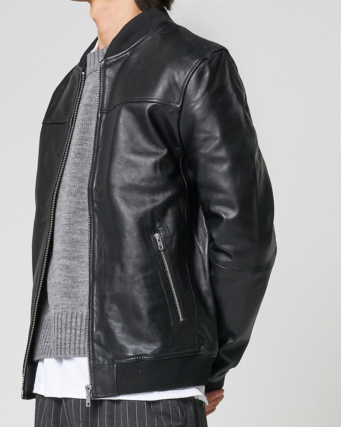 Image shows how the jacket falls when fully unzipped, as worn by a male model. 