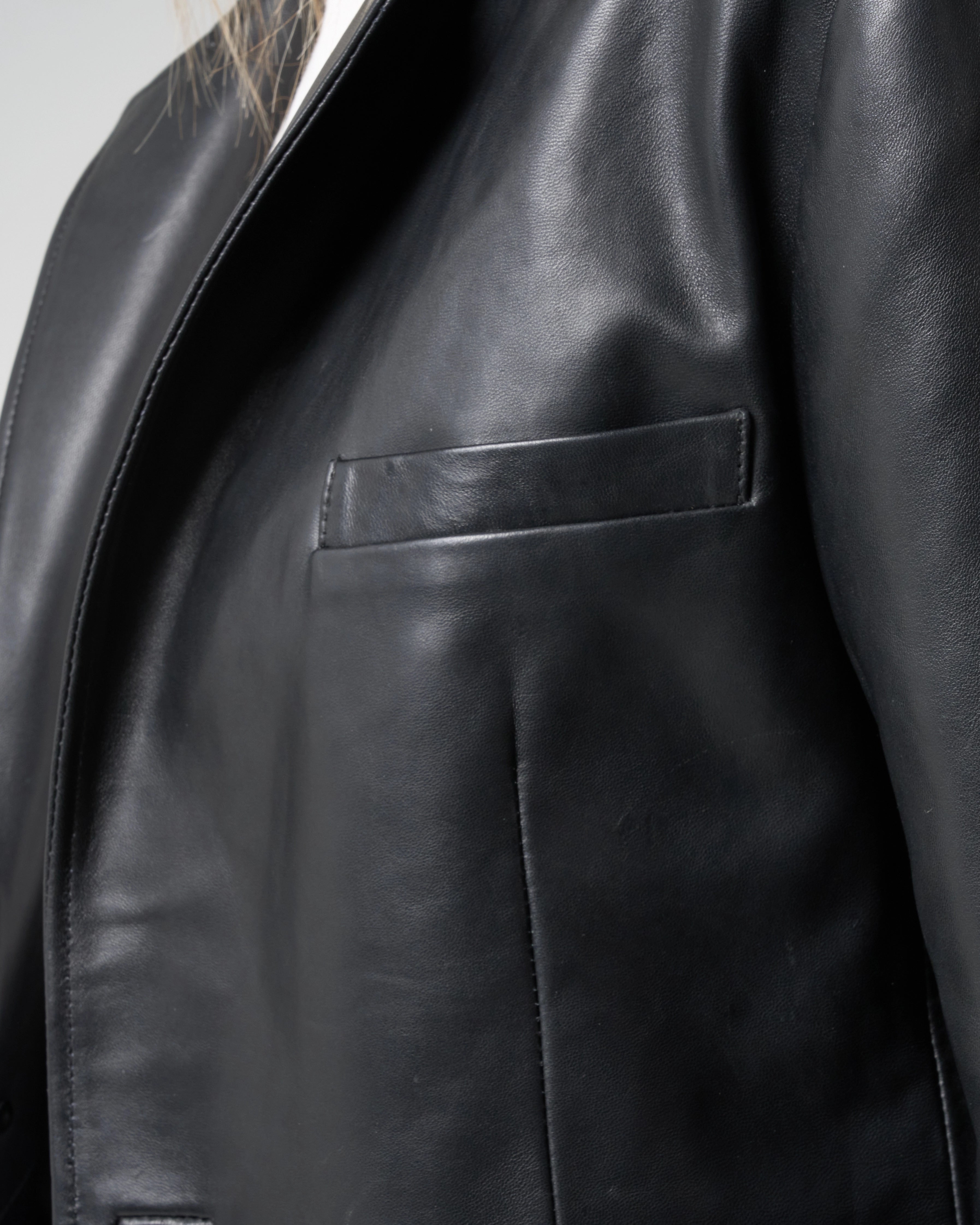 Close up detail mage of soft smooth leather, the image shows the subtle top pocket detail on the leather blazer.
