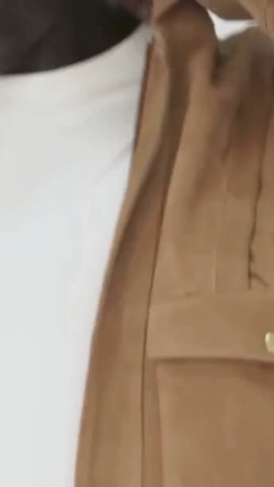 Video shows cropped in footage of a photoshoot where a men wears a suede  jacket by Barneys Originals. He is modelling the item for an ecommerce shoot.